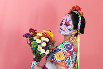 A young woman disguised as a catrina