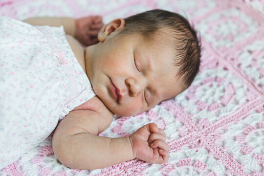 Newborn Baby Girl Sleeping on an Handmade Blanket