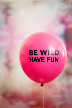 Front view of pink balloon with phrase on it