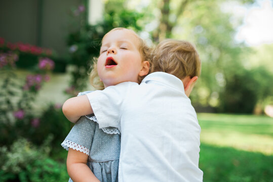 Two young twins playing outside in the summertime