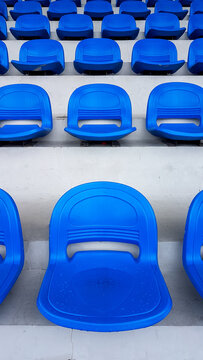 Wet, empty seats in the bleacher section of a stadium.