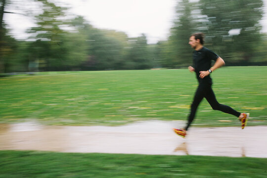 Blurry photo of a man running in the rain
