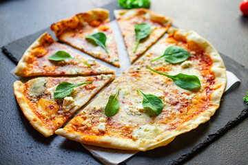 cheese pizza four types of cheeses and different varieties tomato sauce fresh ingredients fast food on the table tasty serving size portion top view copy space for text food background rustic