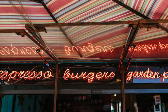Neon Food Sign that reads Espresso / Burgers / Garden Patio
