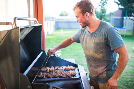 Man cooking pork chops on the BBQ in rural NSW