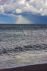 Obraz premium Russia, Kaliningrad region, rainbow and lightning after a storm in the Baltic Sea. Thunderclouds and the sea.