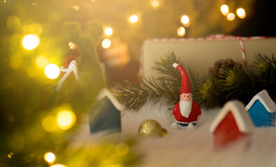 Santa claus dolls with bokeh lights for christmas concept.
