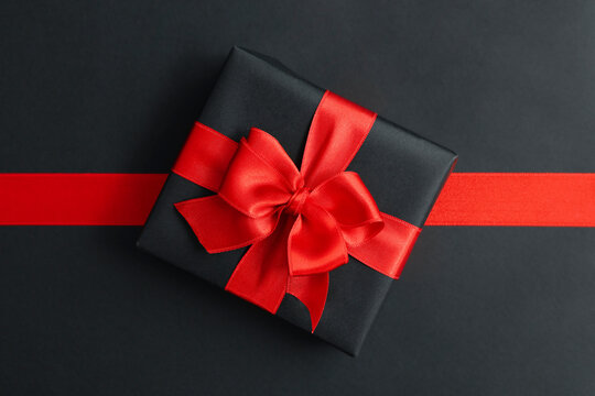 Gift Box And Red Ribbon On Black Background