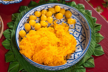 Delicious sweet Thai desserts is local dessert from handcraft that still retain the cultural identity of the old days on natural green banana leaf in wooden basket is favorite of Thailand