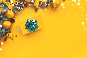 Christmas composition. Gold background with gift box and decorations. Christmas, winter, new year concept. Flat lay, top view, copy space . Holiday concept.