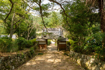 Naklejka premium Approach to Daishu-ji temple in Sanda city, Hyogo, Japan. Translation: Chinese characters on tiles mean the name of the temple