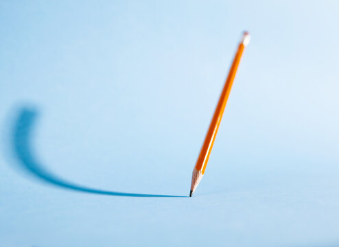 Pencil Floating Against Blue Background