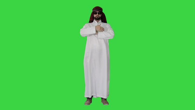 Sheikh in sunglasses sending a kiss on a Green Screen, Chroma Key.