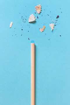 Dull wooden pencil on a blue paper