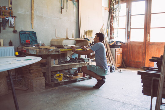 Cabinet Maker Sandblasting a Furniture