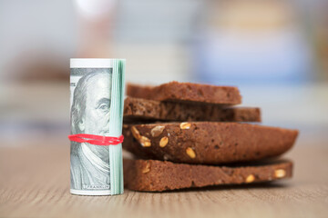 Dollar bills and black bread
