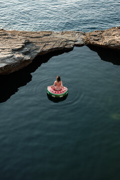 Woman Sitting On Inflatable Tube In The Sea