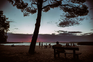 silhouette of a person sitting on a bench