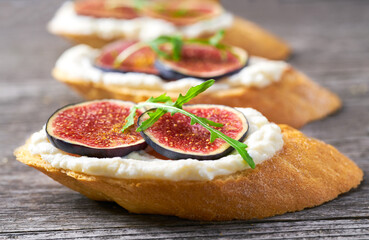 Delicious toast with fig and ricotta cheese close-up