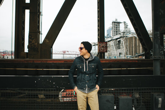 Man wearing a jean jacket standing in an urban setting