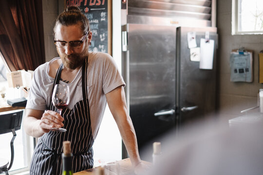 Hip bar owner tending his bar