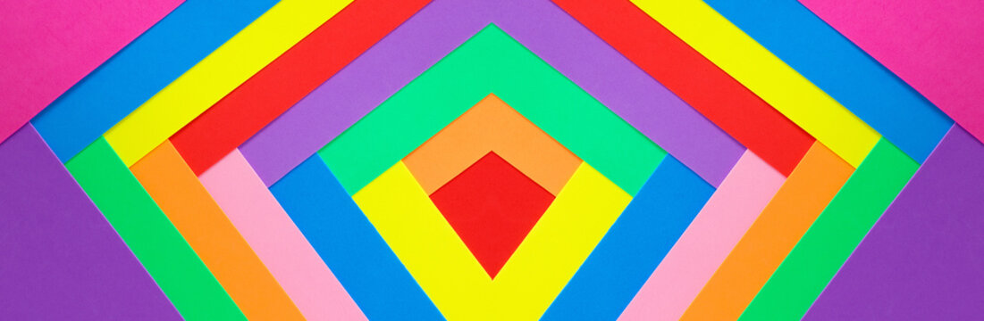 An abstract geometric textured background of multicolored rainbow colors created with overlapping foam craft paper 