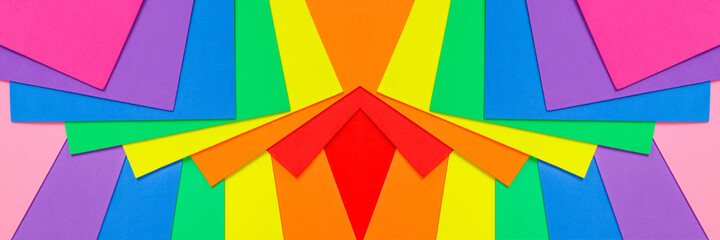 An abstract geometric textured background of multicolored rainbow colors created with overlapping foam craft paper 