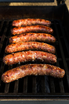 Bratwurst, Kielbasa and red onion on the grill