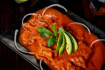 Mexican dish Chicharon in red sauce