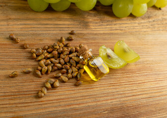 Grape Oil Seed in Small Vintage Bottle on Wooden Rustic Background