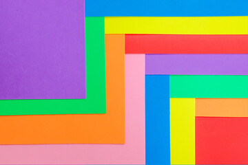 An abstract geometric textured background of multicolored rainbow colors created with overlapping foam craft paper 