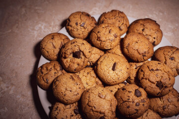 Homemade cookies on a plate with low light