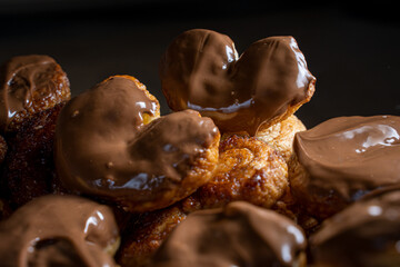 Chocolate palmier biscuits close-up. Heart-shaped puff pastry, pig's ear, palm leaves cookies, elephant ears, french hearts, shoe-soles.