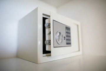 Fototapeta Metal safe inside an empty wooden closet in a hotel room obraz