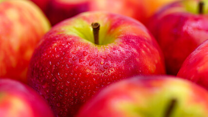 Fresh red apples with drops of water, closeup.