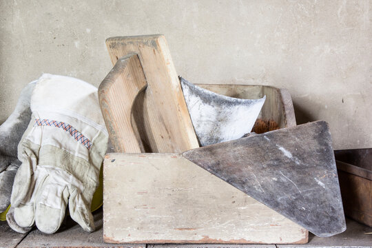 Masonry tools in a box on a shelf