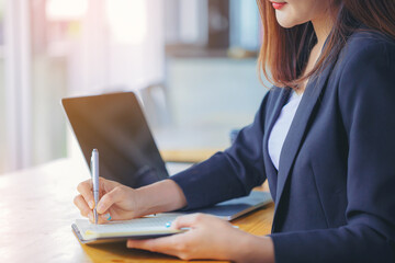 Crop image of businesswoman secretary writing information, boss order in notebook before meeting.	