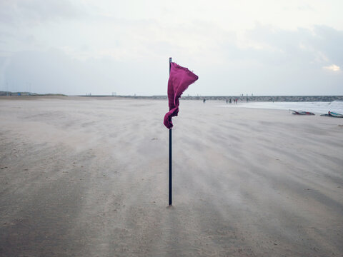 Flag on the beach on a windy day.