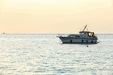 Fototapeta na wymiar Single boat on the sea in evening light