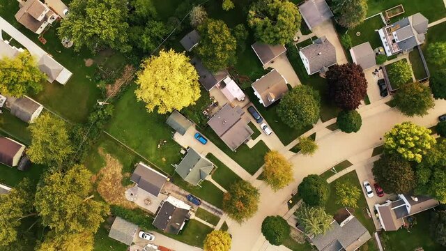 Aerial drone view of American suburban neighborhood. Establishing shot of America's  suburb. Residential single family houses pattern. Autumn Fall season