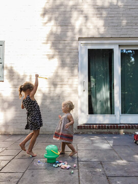 two children play with bubbles