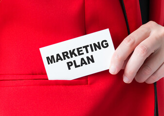 card with the inscription Marketing Plan in the hands of a businessman. Business concept