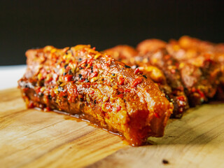 Fresh uncooked pork belly slices on a wooden board, Meat marinated in Korean style marinate. Meat industry product.