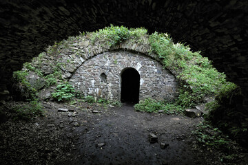 Dark Vikstejn castle vault arch and dark door with single window