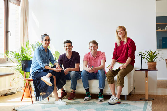 Smiling Design Professionals Sitting In Office