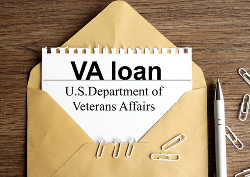 va loan. text on white paper on envelope on wood background
