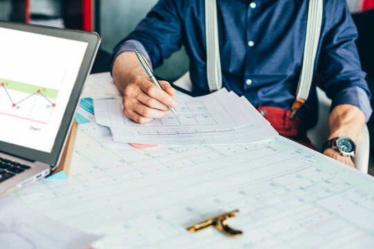 A Man Engineer Working on Blueprints