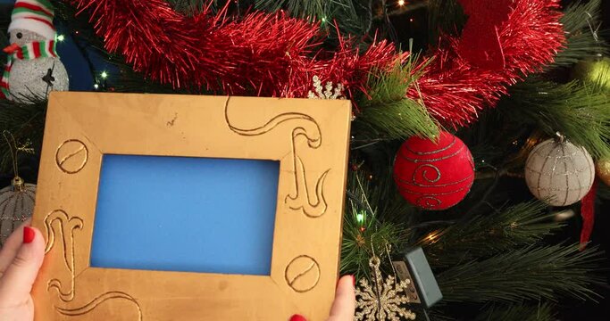 Empty Photo Frame in front of the christmas tree