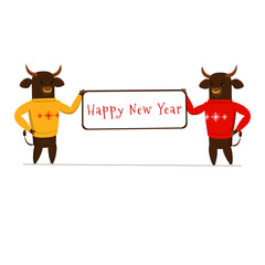 Two bulls, symbols of the new 2021, hold a banner with the inscription Happy New Year. the bulls are wearing red and yellow sweaters.