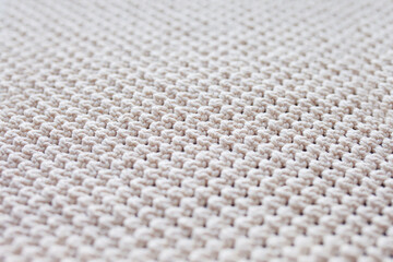 Handmade beige macrame pattern background. Macrame texture, ECO friendly, modern knitting. Macrame rug on wooden table